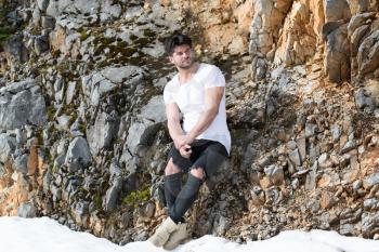 Portrait of Handsome Young Man in Jeans Clothes Looking at Camera - Standing Against Brick Wall on Copy Space