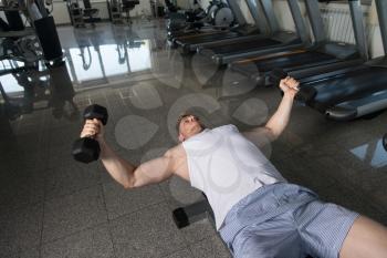 Young Man Working Out Chest In Gym