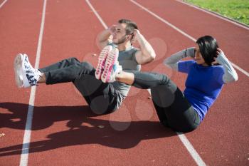 Young Couple Exercising in City Park Area - Training and Exercising for Endurance - Fitness Healthy Lifestyle Concept Outdoor