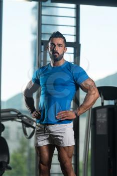 Portrait Of A Young Physically Fit Man In Blue T-shirt Showing His Well Trained Body - Muscular Athletic Bodybuilder Fitness Model Posing After Exercises