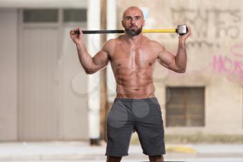 Athletic Man Resting - Workout At Gym With Hammer And Tractor Tire