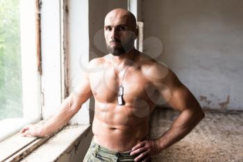 Portrait of a Physically Fit Man Showing His Well Trained Body - Muscular Athletic Bodybuilder Fitness Man Posing After Exercises Inside Ruins