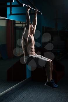 Athlete Performing Hanging Leg Raises Exercise - One Of The Most Effective Ab Exercises