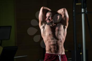 Portrait Of A Young Physically Fit Man Showing His Well Trained Body - Muscular Athletic Bodybuilder Fitness Model Posing After Exercises