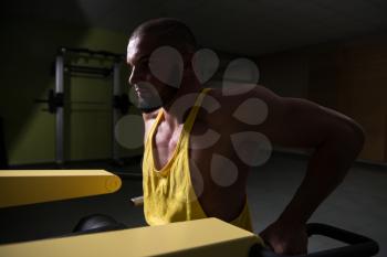 Man Doing Heavy Weight Exercise For Trapezius On Machine
