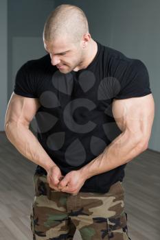 Handsome Young Man Standing Strong In Army Pants And Flexing Muscles - Muscular Athletic Bodybuilder Fitness Model Posing After Exercises