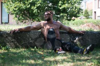 Portrait Of A Mature Physically Fit Tattoo Man Showing His Well Trained Body - Muscular Athletic Bodybuilder Fitness Model Posing After Exercises