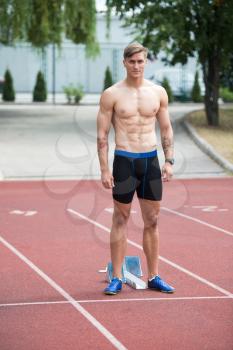 Young Runner Athlete Man Relax and Ready for Run at Athletics Race Track