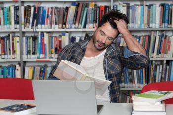 Stressed Student in High School Sitting at the Library Desk