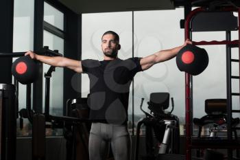 Man Working Out Shoulder In A Gym With Medicine Balls