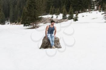 Portrait of a Young Physically Fit Man Showing His Well Trained Body While Wearing Blue Jeans - Muscular Athletic Bodybuilder Fitness Model Posing Outdoors - a Place for Your Text