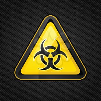 Hazard warning triangle biohazard sign on a corduroy surface