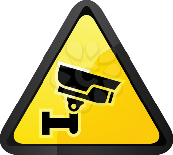 Black surveillance camera on a yellow triangular shape
