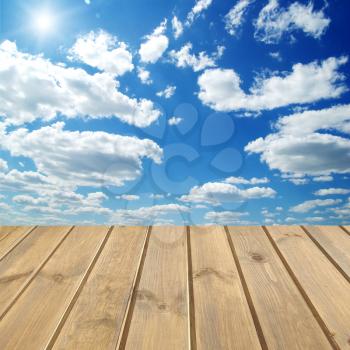 Wooden  floor over a blue sky