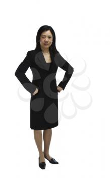 Asian woman dressed in business formal suit with hands on her sides shot on white background