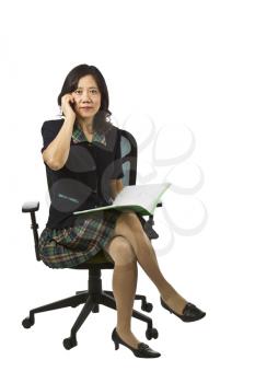 Asian women on cell phone while sitting in chair on white background