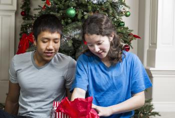 Brother and Sister looking into gift bag on Christmas Day