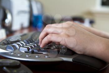 Girl typing on ergonomic wireless keyboard