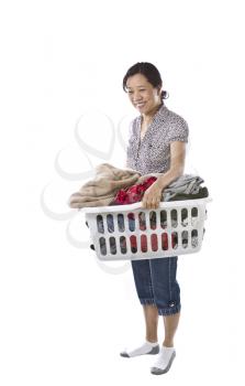 Asian lady with full laundry basket while wearing causal clothing on white background