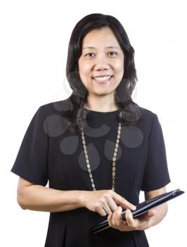 A portrait Vertical photo of a mature Asian woman wearing a dark dress while holding an open folder on a white background