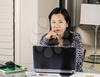 Mature women smiling while working at home office