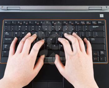 Photo of female hands typing on laptop computer 