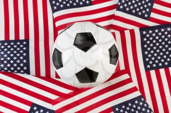 Overhead view of new soccer ball surrounded by United States of America flags