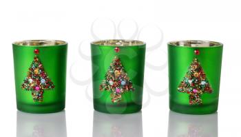 Image of handmade Christmas candle holders on white with reflections