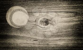 Vintage concept of an old baseball on rustic wood 