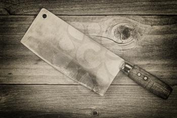 Vintage concept of an large old traditional butcher knife on rustic wood 

