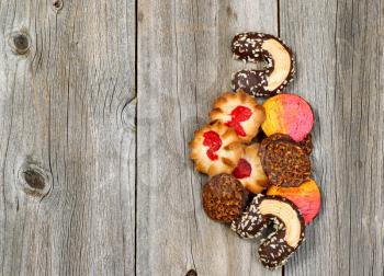 Top view angled shot of assorted cookies forming a line on right side of photo. Plenty of copy space. 
