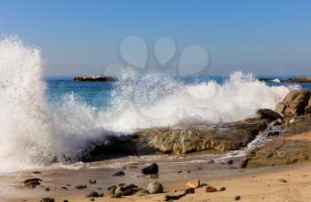 Waves of Pacific Ocean hitting rocks on Laguna Beach in Southern California. 