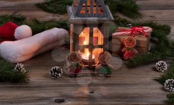 Glowing lantern for the Christmas season on rustic wooden boards.   