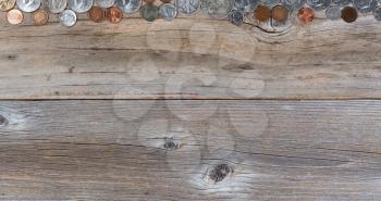 Overhead view of a top border of partial United States vintage coin money on rustic wood