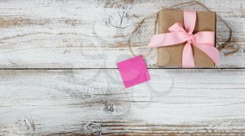 Gift box for romantic celebrations on rustic white wood in flat lay view