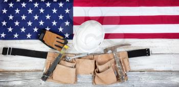 Red, white and blue American flag with industrial tools for Labor Day background