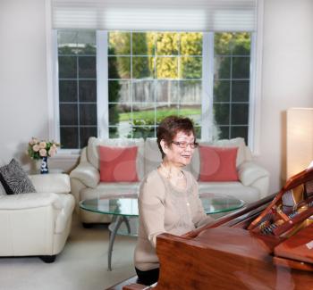 Senior woman playing piano with joy  