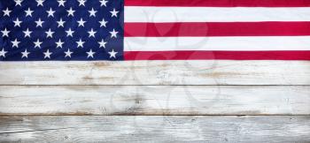 Upper border of red, white and blue American flag for Memorial Day or Veteran Day background on vintage wooden planks
