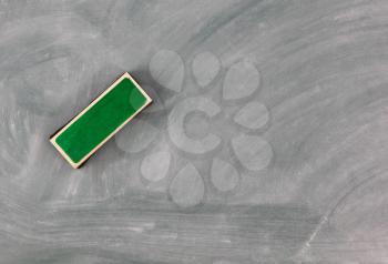 Back to school concept with green erased chalkboard and eraser