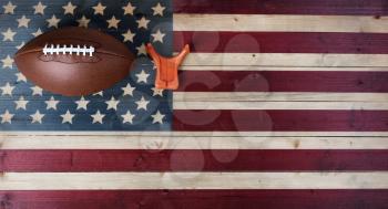 American football with kicking tee on vintage United States wooden flag background. Football sports concept with copy space