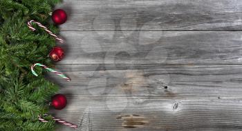 Merry Christmas and Happy New Year holiday concept with decorations on left side of weathered wooden boards