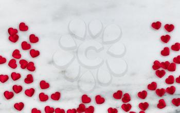 Red lovely hearts on natural marble stone in flay lay composition for Valentines Day concept