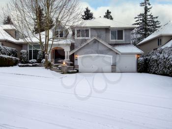 Curb view of a home with freshly fallen snow during the month of December