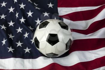 Traditional leather soccer ball with American flag in background 