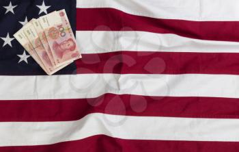 Cloth US flag with Chinese yuan currency for Trade War Concept 