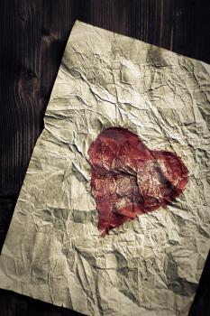 Grunge heart on wooden texture