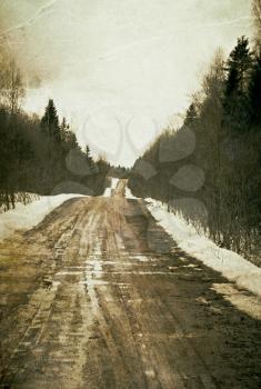 Vintage depressed and deserted village road. Grunge background.