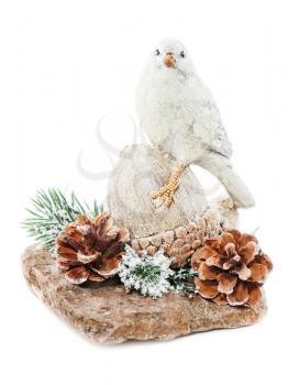 Christmas arrangement of bird on a nut with cones, pine needles and snowflakes isolated on white background