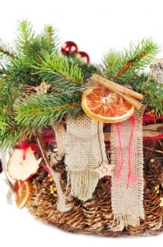 Christmas-tree branch decorated with balls, beads, cinnamon and dried fruit isolated on white background