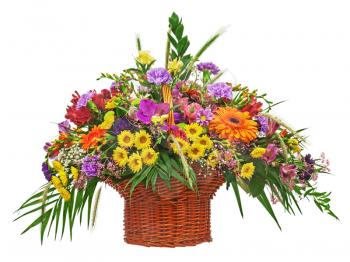Colorful flower bouquet arrangement centerpiece in wicker basket  isolated on white background. Closeup.